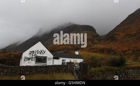 Slogans painted on the cottage owned by Jimmy Savile in Glencoe, Scotland. Stock Photo