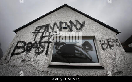 Graffiti on Jimmy Savile's cottage. Slogans painted on the cottage owned by Jimmy Savile in Glencoe, Scotland. Stock Photo