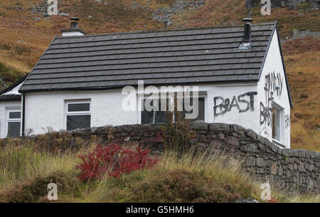 Slogans painted on the cottage owned by Jimmy Savile in Glencoe, Scotland. Stock Photo