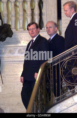 Ulster Unionist Leader David Trimble (L) with two of his three ministers Arts Minister Michael McGimpsey (C) and acting first minister Sir Reg Empey walks to the waiting media at Stormont, near Belfast. * Trimble announced that UPP ministers will quit the Northern Ireland power-sharing executive as of midnight tonight, with the hope that it will force the IRA to start decommissioning their weapons. Stock Photo