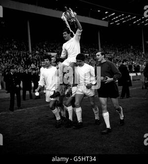 QPR players (from l-r) Ron Hunt, Roger Morgan, Les Allen, Ian Morgan, captain Mike Keen (being carried),Tony Hazel and Peter Springett parade the League Cup trophy after beating West Bromwich Albion 3-2 at Wembley. Stock Photo