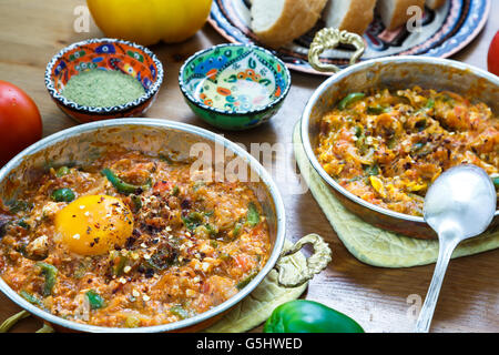 Menemen Turkish breakfast food egg, tomatoes and pepper in pan with concept background Stock Photo