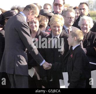 The Duke of Kent shakes hand with nine year old Jay Wilkinson, the great-great-grandson of Private Harry Wilkinson, after the First World War soldier was finally laid to rest at Prowes Point Cemetery, Commines-Warneton, Hainaut in Belgium. * Wilkinson, 29, from Bury, Lancashire of the 2nd Battalion Lancashire Fusiliers, was killed in action on November 10, 1914, in a field in Belgium. His remains with his identity tag and his and Lancashire Fusiliers cap badge were found only 87 years later, in January last year in the field at Ploegsteert Wood. Stock Photo