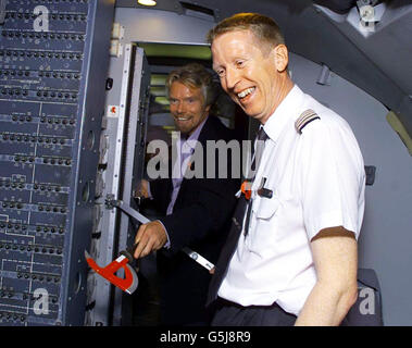 Virgin Atlantic showcases new security measures on board Virgin Atlantic planes it is strengthening its flight deck doors by reinforcing them with Permaglass X armour plating capable of withstanding attacks by knife hatchet and hand guns. Showing the door captian Sir Richard Branson and London Mayor Ken Livingstone on board his plane bound for New York. Stock Photo