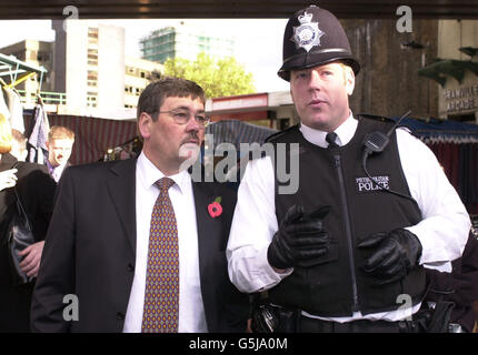 Home Office Minister Bob Ainsworth with a police officer during his visit to Brixton, south London, where he inspected a pilot scheme in which cannabis users are cautioned by police instead of being arrested. Stock Photo