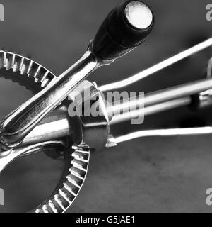 Closeup detail of an old fashioned hand mixer on a gray metal surface. Stock Photo