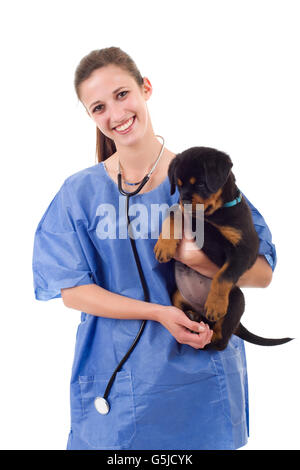 Brunette veterinary with a rottweiler puppy dog isolated on white background Stock Photo