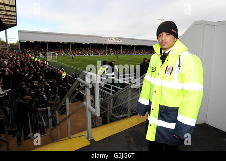 Fulham stewards help fans around the stadium on match day Stock Photo