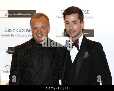 Graham Norton (left) and partner Trevor Patterson arriving at the Grey Goose Winter Ball in aid of the Elton John AIDS Foundation at Battersea Power Station, London. Stock Photo