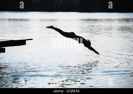 woman jumping into the lake