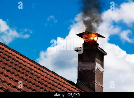 Chimmney on fire with smoke coming out. Stock Photo