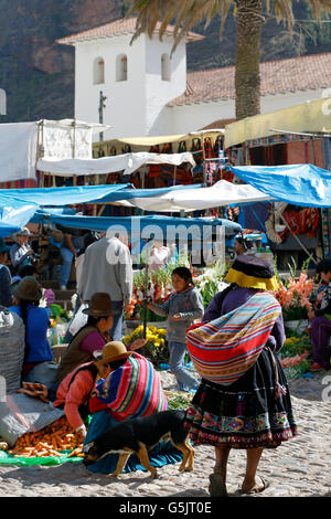 Sunday Market, bell tower of San Pedro Apostol (St. Peter the Apostle) Church in background, Pisac, Cusco, Peru Stock Photo