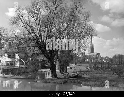 A view of Norwich Cathedral and Pull's Ferry watergate on the River Wensum. Stones from Normandy were brought through the waterway during the building of the cathedral, which has a 315-foot spire. Stock Photo