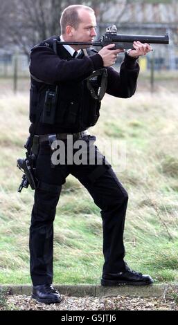 Pc Mick Pinsent from the Firearms Unit of Bedfordshire. Police gives a demonstration of the new Heckler Koch baton gun in Cardington, Bedford. * ...... Bedfordshire will be the first force in the country to use a new style baton gun similar to weaponry used by police in Northern Ireland. It is the first time police in mainland UK will have carried weapons which are less lethal than ordinary firearms, but more powerful than CS Spray. Stock Photo