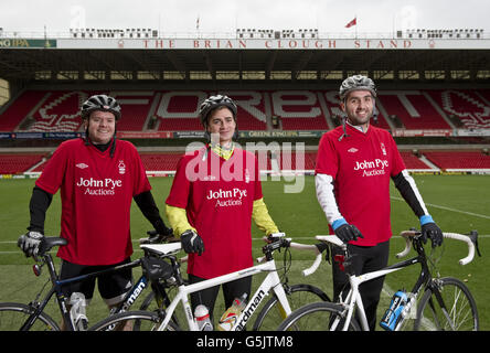 Cyclists Rowan Staszkiewicz, Scott Wilson and Matthew Vincent pitchside before their 26 mile bike ride from The City Ground, Nottingham to the King Power Stadium, Leicester to raise money for Prostate Cancer UK and the Alzheimer's Society. Stock Photo