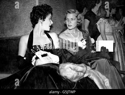 Hollywood star Elizabeth Taylor (left) chatting with a friend at the Warner Theatre, before the world premiere of British film The Lady with the Lamp. Stock Photo