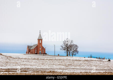 Church and cemetery on a hill surrounded by grain fields in rural north east Nebraska Stock Photo