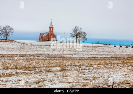 Church and cemetery on a hill surrounded by grain fields in rural north east Nebraska Stock Photo