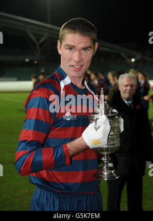 Lance Corporal James Hubbard, captain of the Royal Engineers football team holds aloft the original FA Cup after his team beat the Wanderers in a replay of the 1872 final Stock Photo