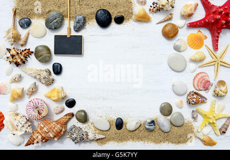Sand, seashells and starfish on a white wooden background Stock Photo