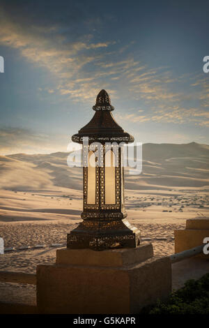 Ornate lantern on wall in desert Stock Photo