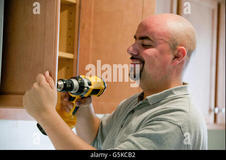 Contractor using power drill in house Stock Photo