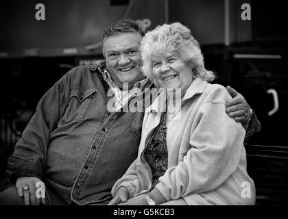 Older Caucasian couple hugging outdoors Stock Photo