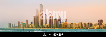 View of Abu Dhabi Skyline at sunset, United Arab Emirates Stock Photo