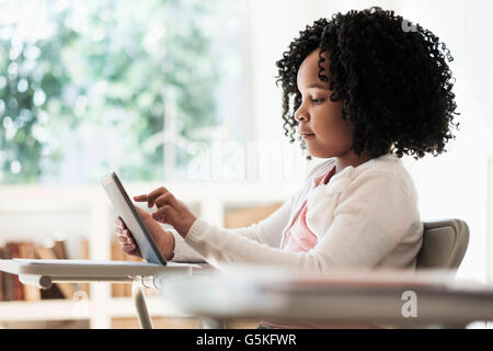 African American student using digital tablet in classroom Stock Photo