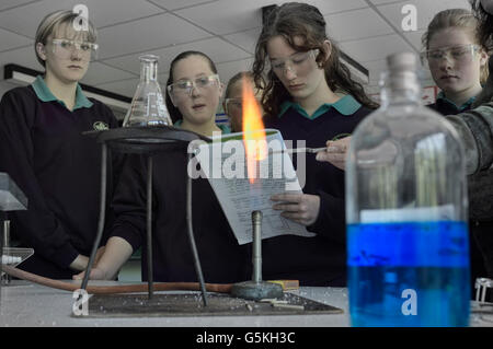 Schoolgirls conducting an experiment in the science classroom. England. UK Stock Photo