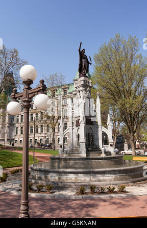 QUEBEC CITY - MAY 23, 2016: The gothic-style fountain at place d'Armes is crowned by Monument de la Foi and commemorates the 300 Stock Photo