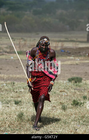 Masai man walking though a barren field in the Masai Village, Kenya, Africa. Stock Photo