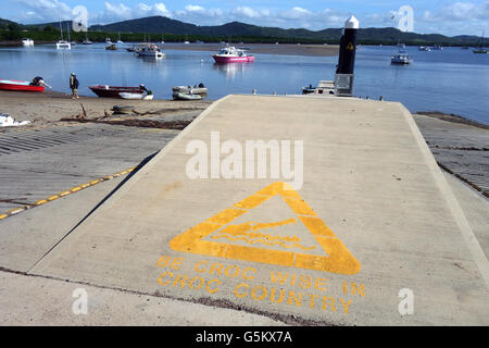 Yellow warning sign about crocodiles at Endeavour River boat ramp, Cooktown, Queensland, Australia. No MR or PR Stock Photo