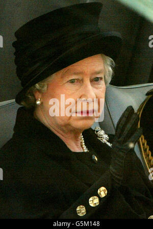 Britain's Queen Elizabeth II waves from her car as she is driven back to Buckingham Palace after the ceremonial procession of the Queen Mother's coffin to Westminster Hall in central London. *Thousands of mourners lined the route to pay their last respects to the Queen Mother who died aged 101. The funeral will take place on April 9 after which she will be interred at St George's Chapel in Windsor next to her late husband King George VI. Stock Photo