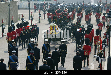 The coffin of the Queen Mother is carried on a gun carriage from the Queen's Chapel to Westminster Hall for the lying-in-state. Thousands of mourners lined the route to pay their last respects to the Queen Mother who died last Saturday aged 101. * Her funeral will take place on April 9 after which she will be interred at St George's Chapel in Windsor next to her late husband King George VI. Stock Photo