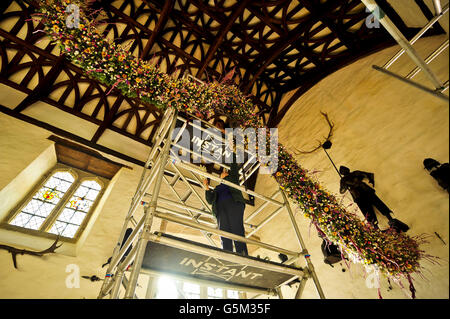 Volunteers at Cotehele National Trust mansion work on a stunning 60ft garland made from dried flowers, which forms an integral part of the Christmas display at the property. Despite a very tough growing year, National Trust staff, volunteers and members of the public at Cotehele in Cornwall, are beginning the meticulous process of creating the longest Christmas garland at any Trust property in the country. Stock Photo