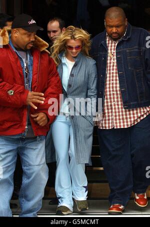 Singer Britney Spears flanked by her minders leaving the Mandarin Oriental Hotel in Knightsbridge, London, during her whirlwind promotional visit to the UK. Stock Photo