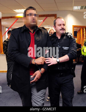 FACE PIXILATED BY PA PICTURE DESK A member of staff is arrested as part of a UK Border Agency raid into suspected immigration offences at Leeds Professional College, Leeds. Stock Photo