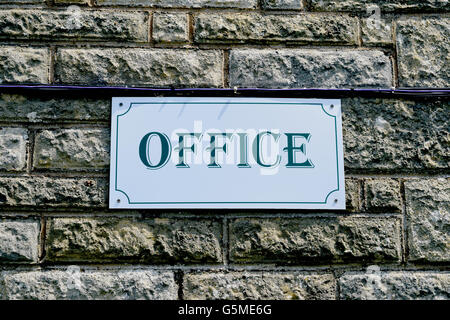 Modern Office Sign on a Brick Wall Stock Photo