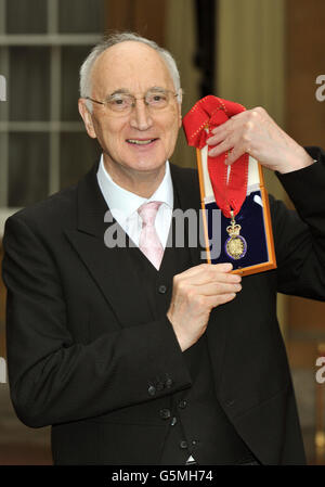 Sir George Young holds his insignia of Knighthood, which was awarded to him by Queen Elizabeth II during an Investiture ceremony at Buckingham Palace in central London. Stock Photo