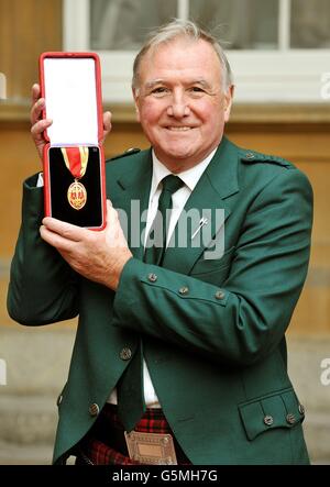 The Right Honourable Sir Malcolm Bruce from Banchory, holds his insignia of Knighthood, which was awarded to him by Queen Elizabeth II during an Investiture ceremony at Buckingham Palace in central London. Stock Photo