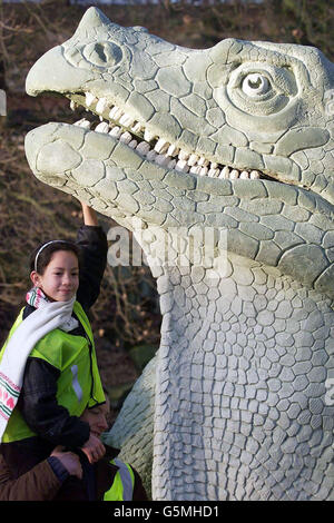 Imogen Smith, aged 8, from Buckinghamshire, poses with a model Iguanodon at Crystal Palace Park, London. *...The world's first dinosaur and prehistoric animal park containing 29 amazing life-size statues has been restored to its former glory almost 150 years after it was first built. The project is part of Bromley Council's 3.6 million restoration of historic Crystal Palace park, and forms part of a Geological Time Trail, tracing the geological history of Britain over billions of years, and was completed with the help of experts at London's Greenwich University. Stock Photo