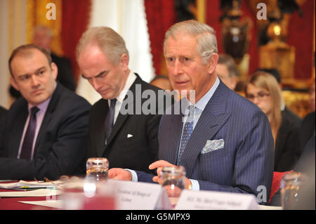 (left to right) Secretary of State for Engery and Climate Change, Ed Davey, Justin Mundy, Head of Prince's International Sustainability Unit (ISU), listen as the Prince of Wales, talks during a meeting of international leaders to discuss curbing world deforestation, in the Thorne Room at Clarence House, London. Stock Photo