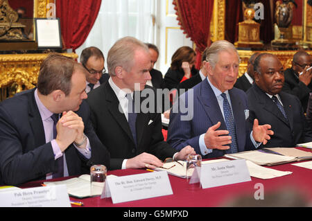 (left to right) Secretary of State for Energy and Climate Change, Ed Davey, Justin Mundy, Head of Prince's International (Unit (ISU) and His Excellency Mr. Ali Bongo President of Gabon, listen as the Prince of Wales (2nd right) , talks during a meeting of international leaders to discuss curbing world deforestation, in the Thorne Room at Clarence House, London. Stock Photo