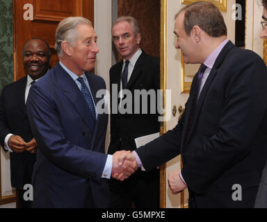 The Prince of Wales, greets Secretary of State for Energy and Climate Change, Ed Davey, prior to hosting a meeting of international leaders to discuss curbing world deforestation, in the Thorne Room at Clarence House, London. Stock Photo