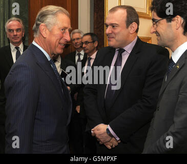 The Prince of Wales, greets Secretary of State for Energy and Climate Change, Ed Davey (centre), prior to hosting a meeting of international leaders to discuss curbing world deforestation, in the Thorne Room at Clarence House, London. Stock Photo