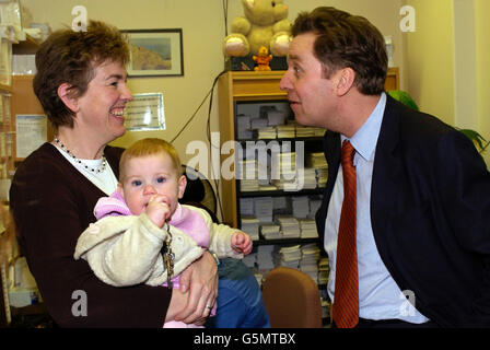 Health Secretary Alan Milburn meets Jane Hole and nine month old daughter Elizabeth during a visit to the Day Surgery Centre at Kings College Hospital NHS Trust, Denmark Hill London. * Mr Milburn pledged to increase the number of operations carried out without an overnight stay in hospital in the latest Government bid to slash waiting times and meet their promise to have no-one waiting more than six months for treatment by 2005. Stock Photo