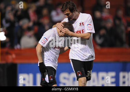 Leyton Orient's Dean Cox (left) celebrates scoring his teams fourth goal of the game with teammate David Mooney (right) Stock Photo