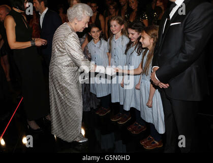 Queen Elizabeth II greets performers from the musical 'Matilda' after the Royal Variety Performance at the Royal Albert Hall in London. Stock Photo