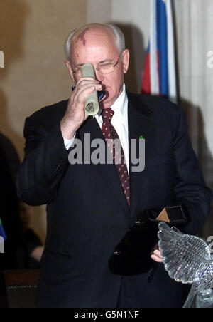 Former President of the Soviet Union, Mikhail Gorbachev examines closely the scroll on which the Freedom of the City of Dublin is inscribed, during a ceremony at Dublin's City Hall, Ireland. * Gorbachev said the 'economic shock therapy' of his successor, former President Boris Yeltsin, to open up unprepared industries to foreign competition had destroyed many areas of the economy and that Russia needed to stem the brain drain of its brightest people. Stock Photo